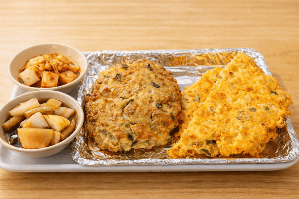 Traditional Korean pancake set served with kimchi and pickled radish at Gwangjang Market