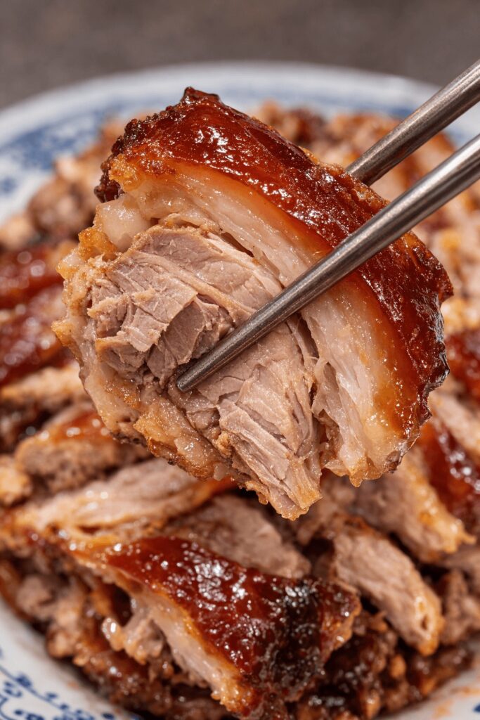 Tender Korean jokbal pork picked up with chopsticks at Halmaejip in Jongno