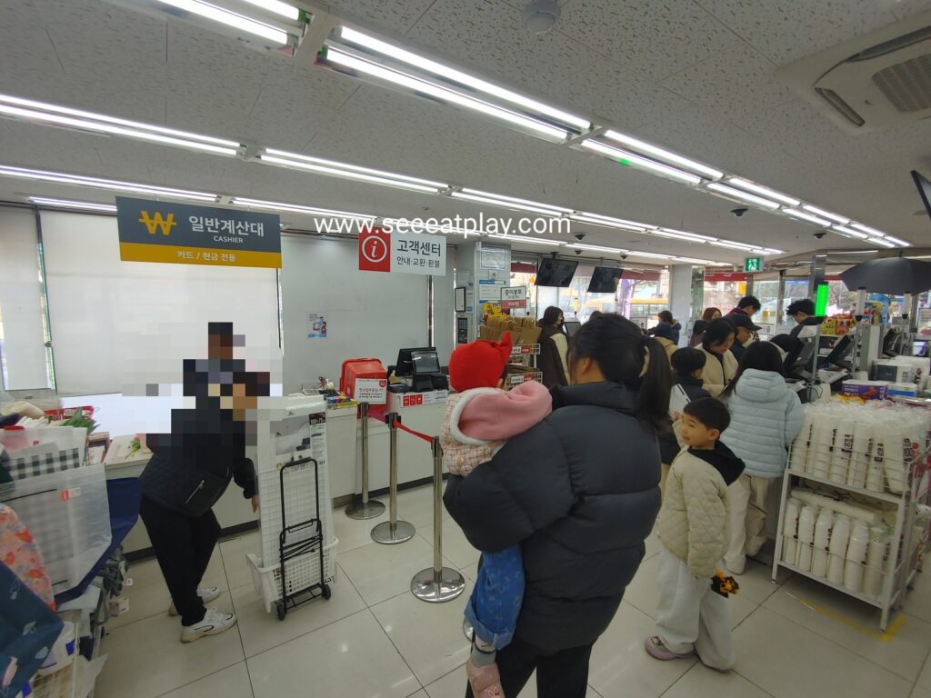 Customers waiting at the cashier counter inside Daiso Jongno store in Seoul