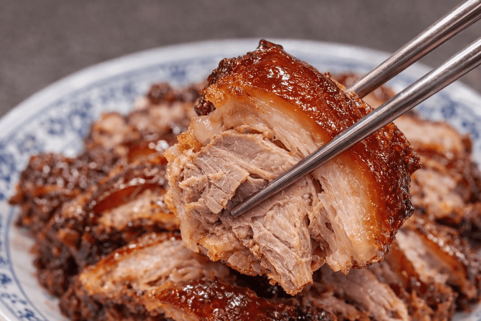 Korean jokbal pork hock held with chopsticks at Halmaejip Jokbal in Jongno