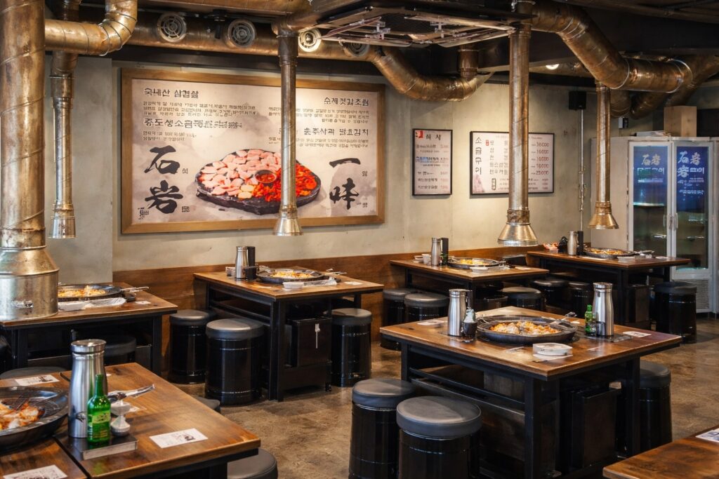 Interior of a Korean BBQ restaurant in Jongno with traditional grill tables and ventilation system