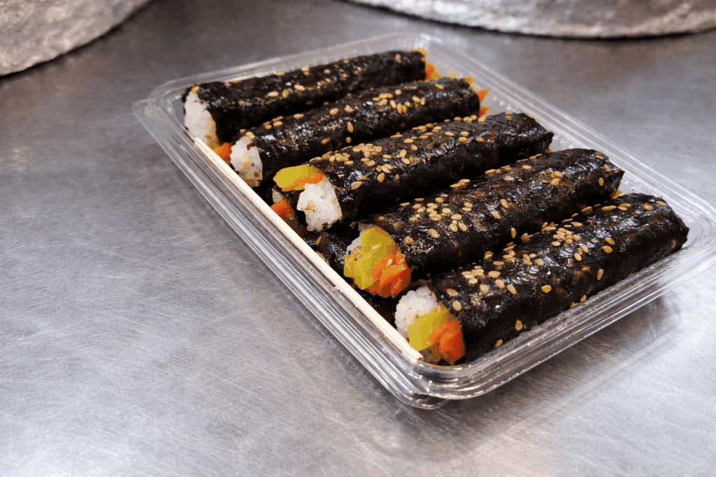 Close-up of mayak kimbap Korean mini seaweed rice rolls at Gwangjang Market Seoul