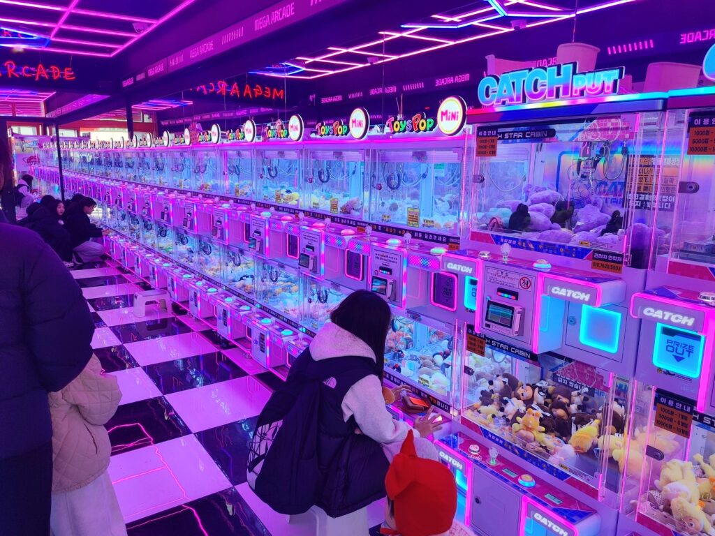 Long row of claw machines in a modern arcade in Jongno Seoul