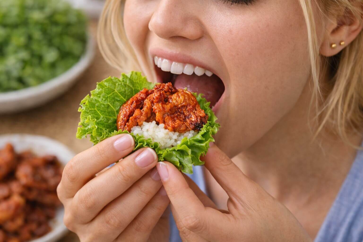Tourist eating Korean lettuce wrap with spicy pork and rice