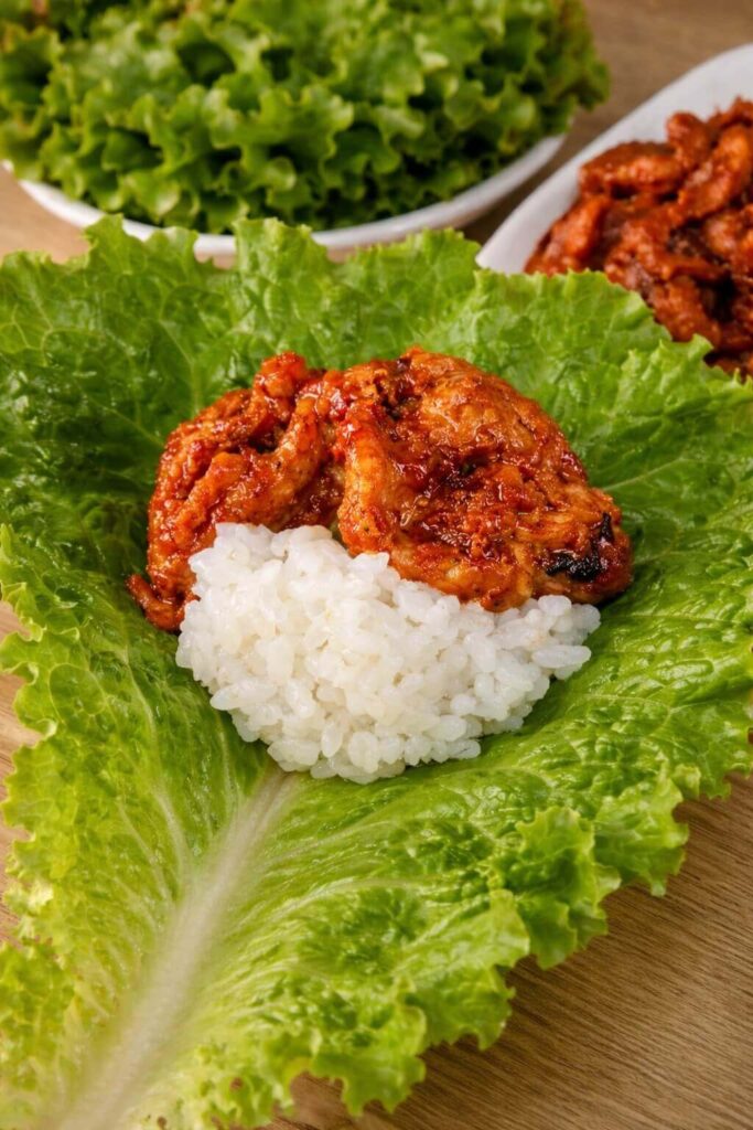 Close up of Korean lettuce wrap with spicy pork and rice