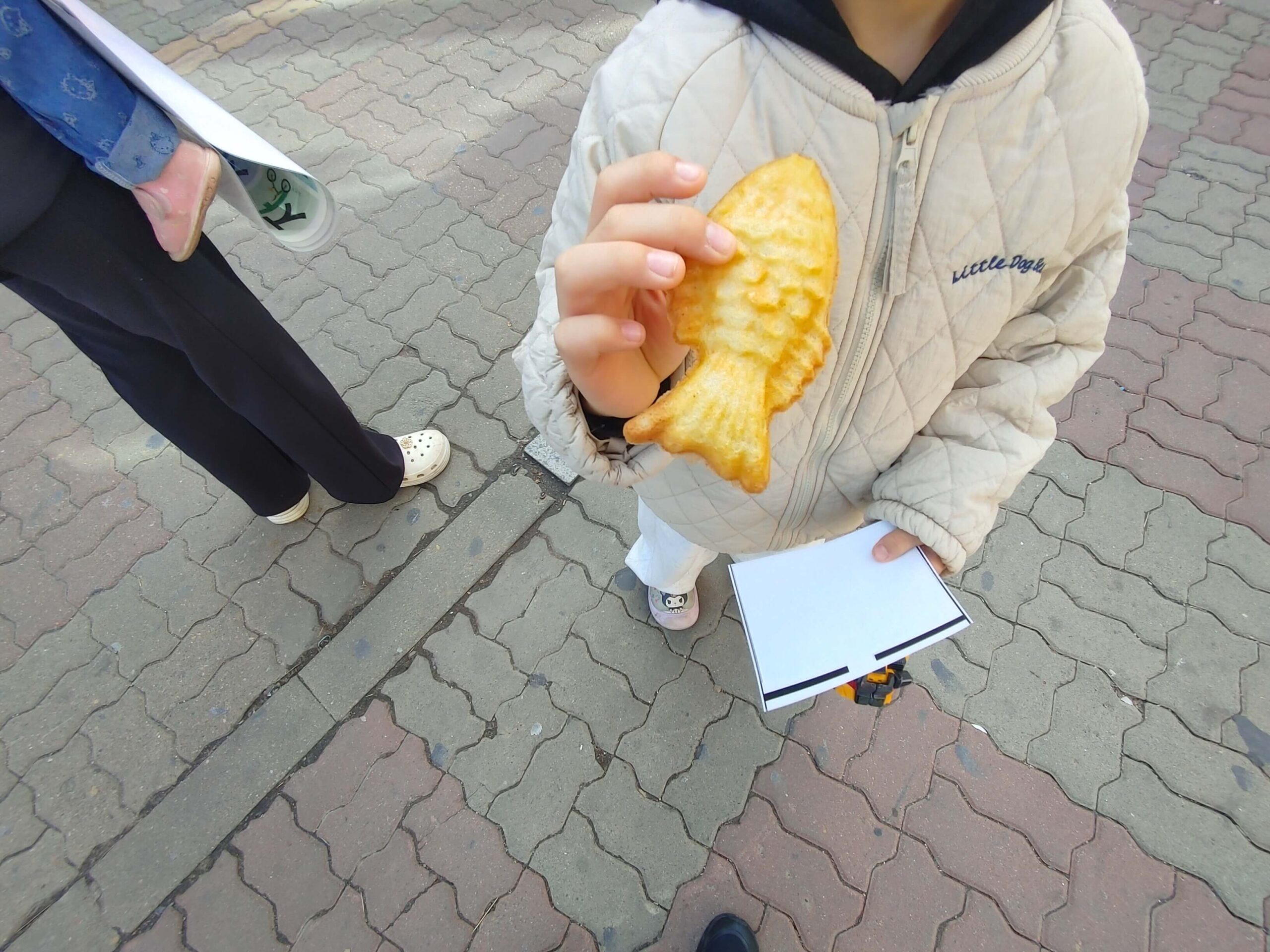 Korean fish-shaped pastry bungeoppang held by a child in Jongno Seoul