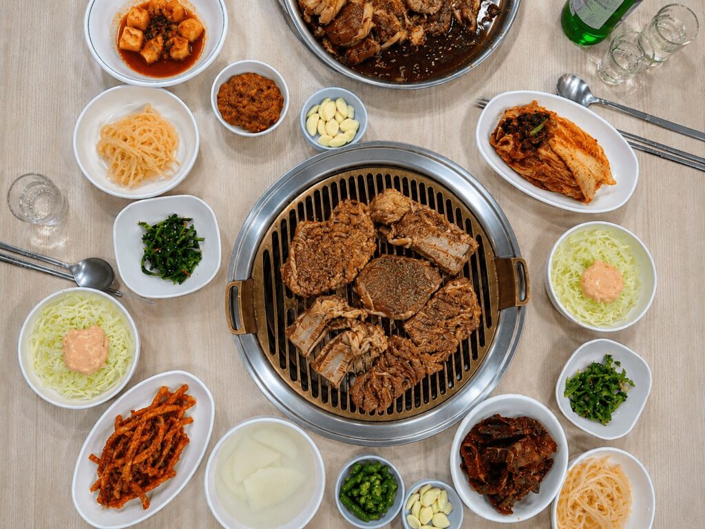 Full Korean BBQ table set with pork galbi and side dishes in Jongno