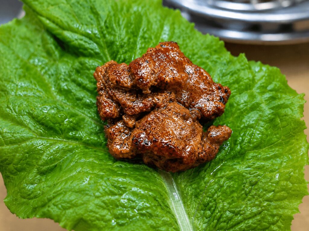 Korean pork galbi wrapped in fresh lettuce at Jongno BBQ restaurant