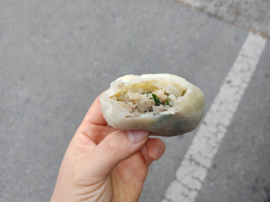 Pork wang mandu bitten showing juicy meat filling in Jongno Seoul Korean street food