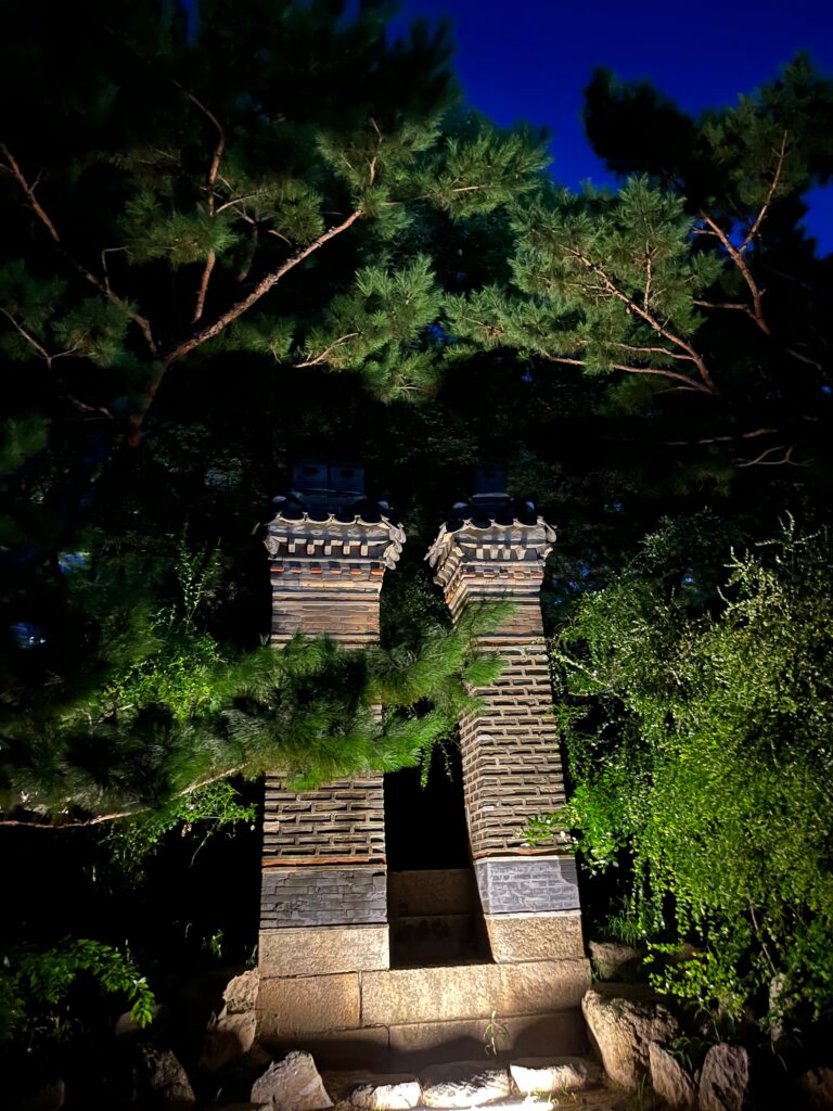 Historic brick chimneys in the Deoksugung garden at night