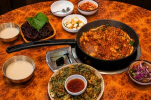 Korean dakgalbi meal with pajeon, side dishes, and makgeolli near Seongsu