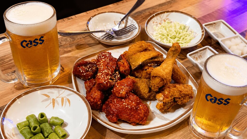 Korean half-and-half fried chicken with original and seasoned chicken served with cold Cass beer at a local chicken restaurant near Seongsu Station.
