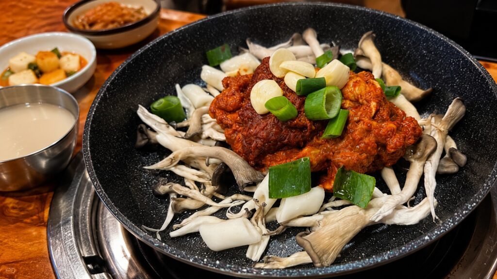 Korean spicy mushroom stir-fry with oyster mushrooms and green onions near Seongsu