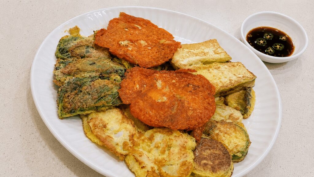 Assorted Korean jeon platter with kimchi pancake, zucchini, tofu, and vegetable pancakes at a local Seongsu restaurant.
