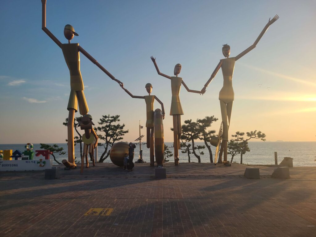 Sunset and family sculpture at Daecheon Beach in Boryeong, South Korea