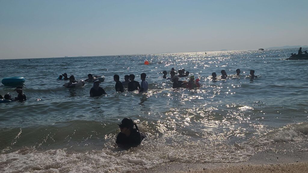 People swimming in the sea at Daecheon Beach in Boryeong, South Korea
