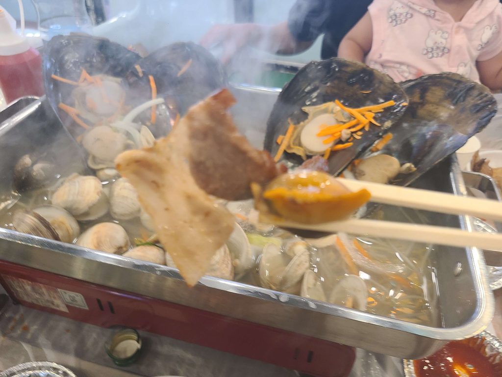Shellfish and pork cooking together in Korea