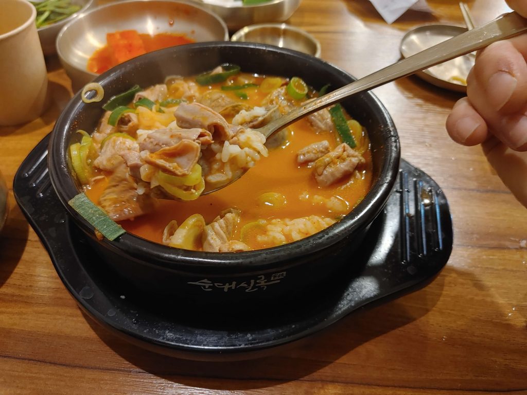 Spicy gopchang sundae soup with pork and green onions