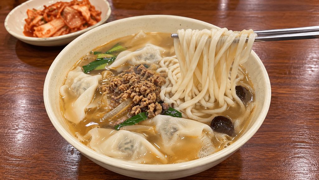 Lifting Kalguksu Noodles at Myeongdong Kyoja in Seoul