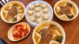 Three-person meal with kalguksu, mandu and kimchi at Myeongdong Kyoja in Seoul