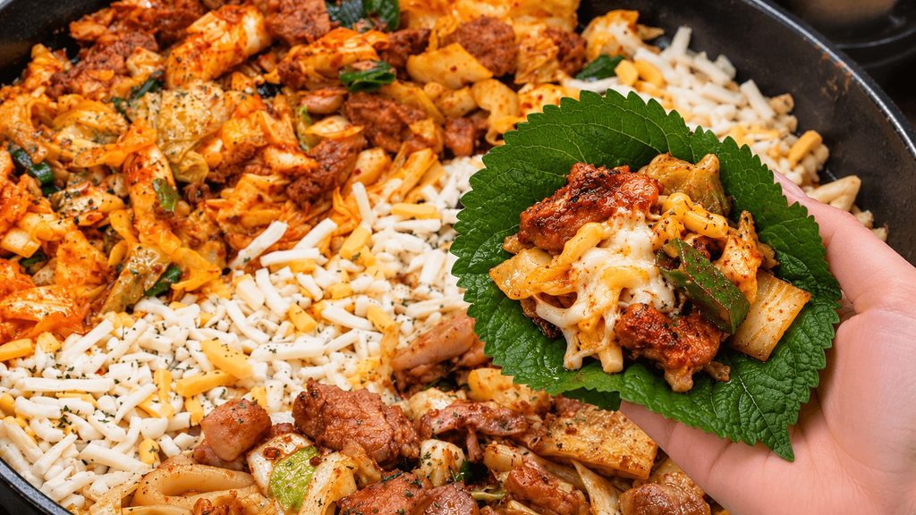 Spicy Yoogane dakgalbi with cheese wrapped in a perilla leaf